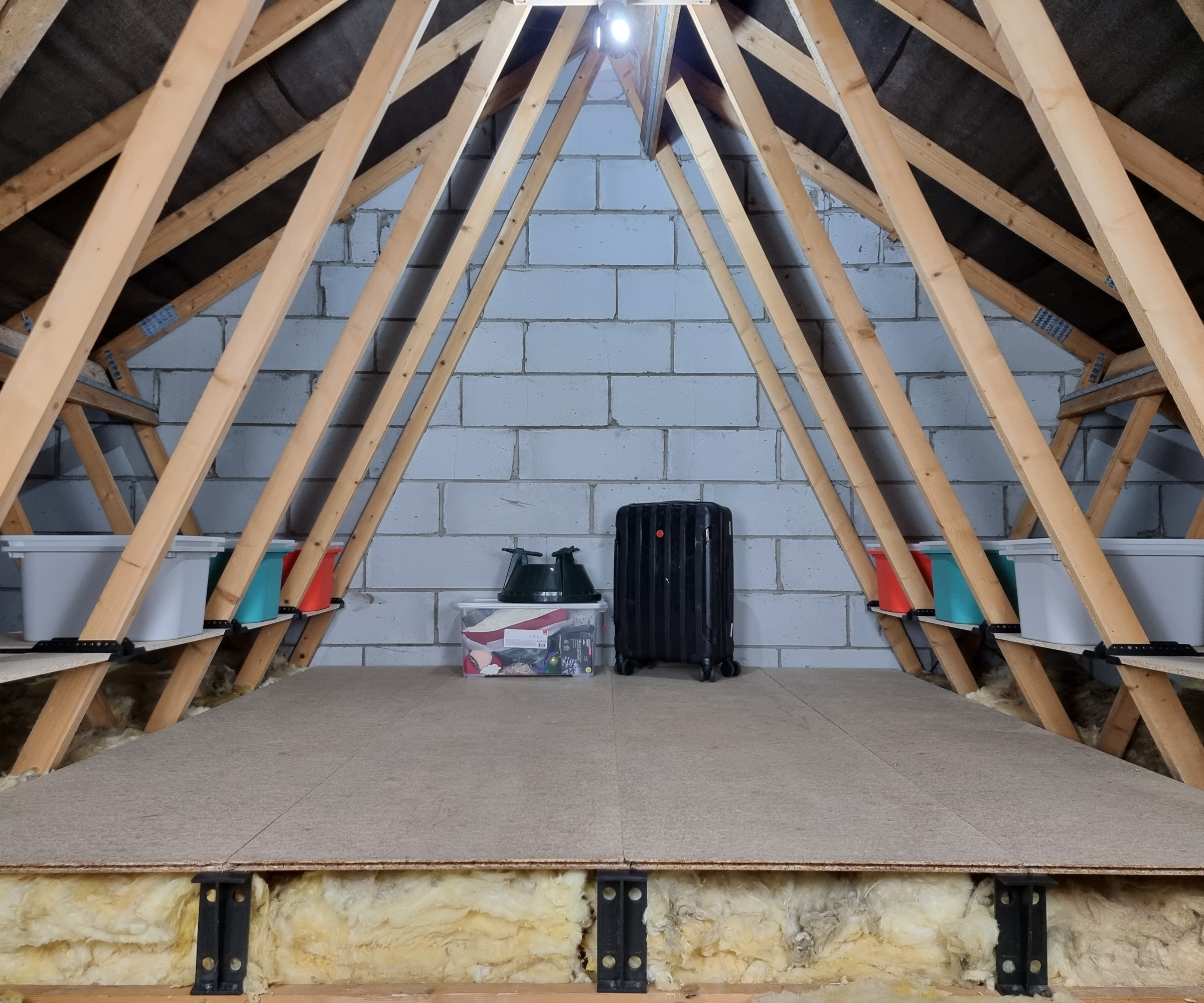 cross section of loft showing boards on loft legs with additional shelves in the eaves