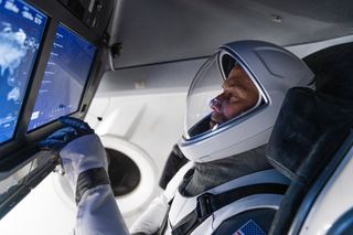 Crew-3 pilot Tom Marshburn poses for a inside SpaceX's Crew Dragon spacecraft.