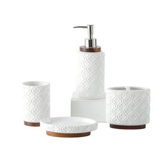 A set of four white ceramic bathroom accessories