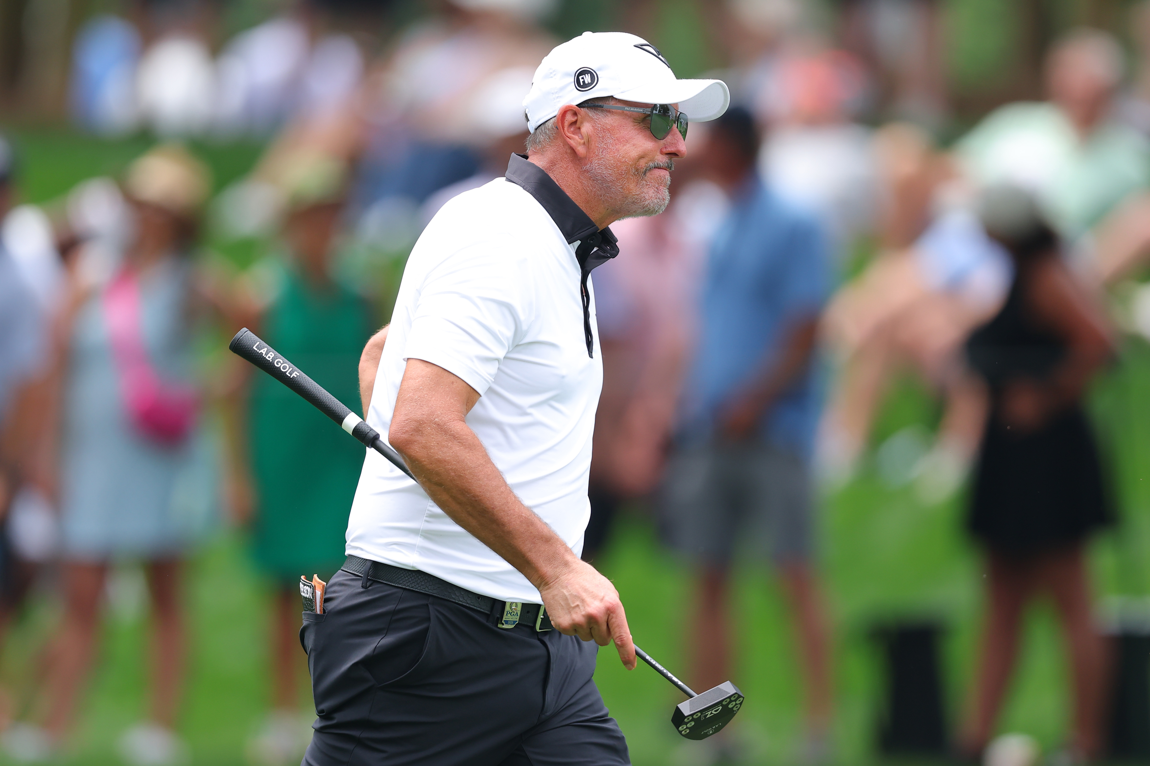 Phil Mickelson walks on the green
