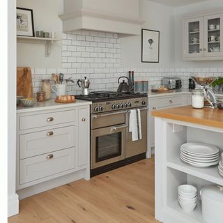 kitchen with white wall white cabinets and wooden flooring