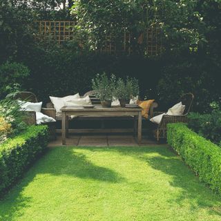 A garden with green grass and garden furniture