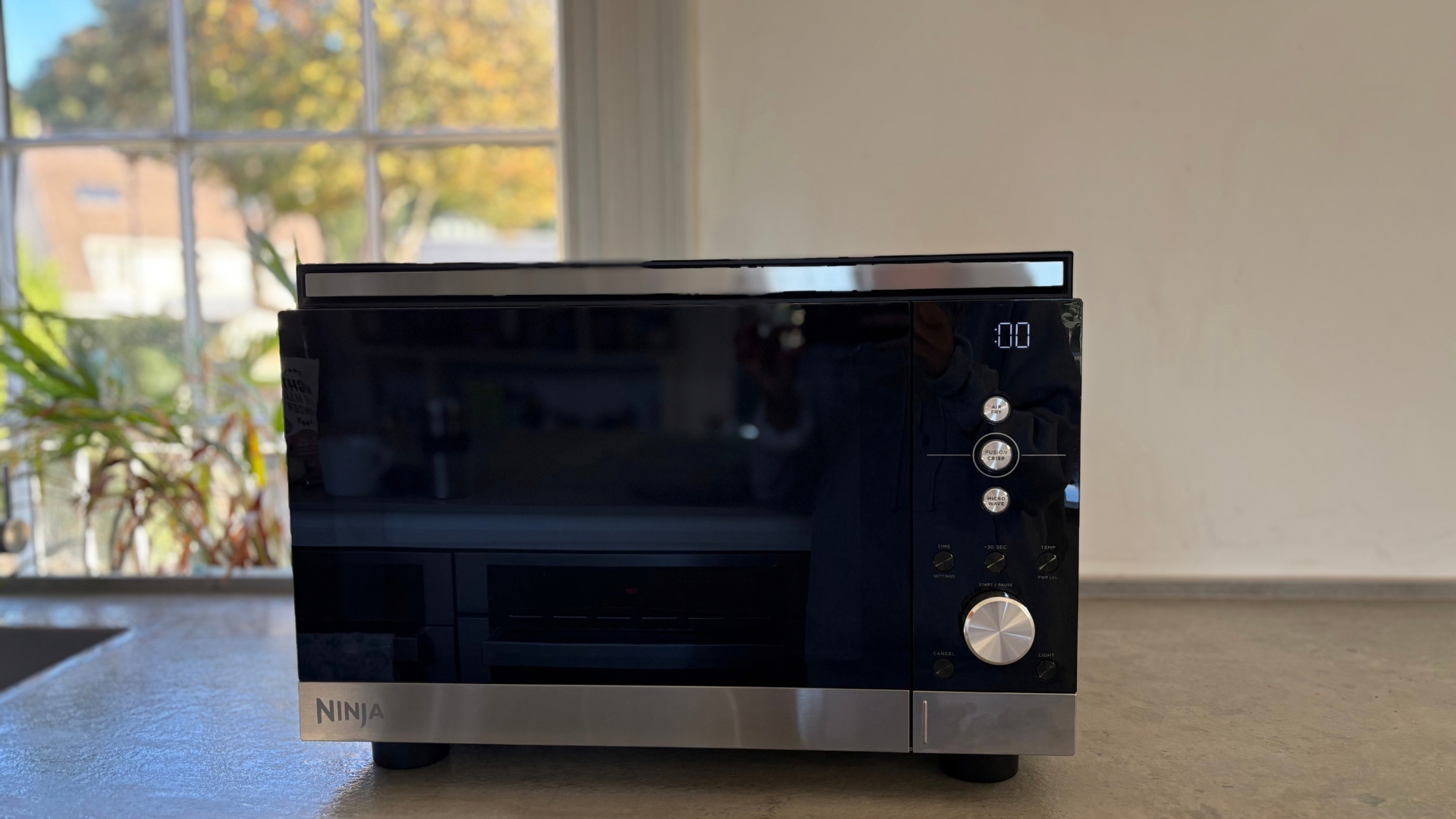 Showing the Ninja Crispi Microwave Air Fryer and Oven on the counter