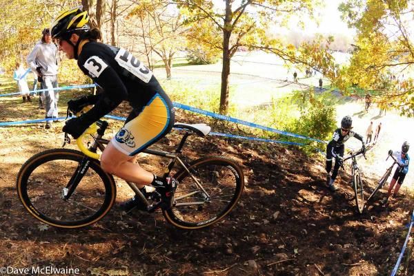 Andrea Smith (Ladies First Racing) riding a steep run-up while Annis and Van Gilder are forced off their bikes