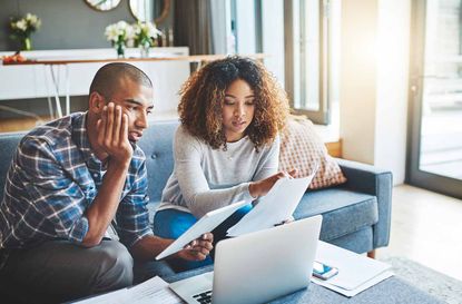 Shot of a young couple going through their paperwork together at home