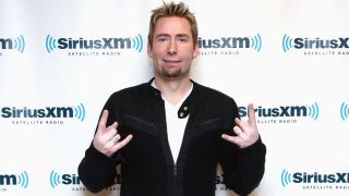 Chad Kroeger throwing the horns