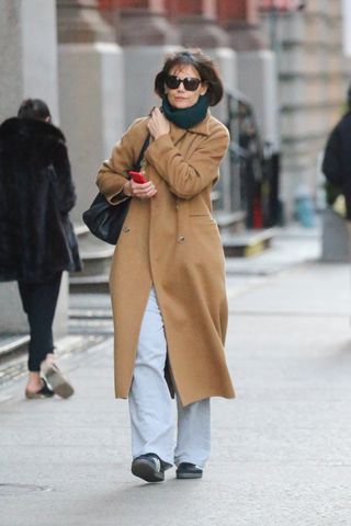 Katie Holmes walking in manhattan wearing a camel coat and Adidas Sambas