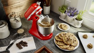 A kitchenAid stand mixer being used on a kitchen countertop