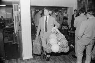 Bulgaria striker Dinko Dermendzhiev carrying a bag of balls for training during the 1966 World Cup.