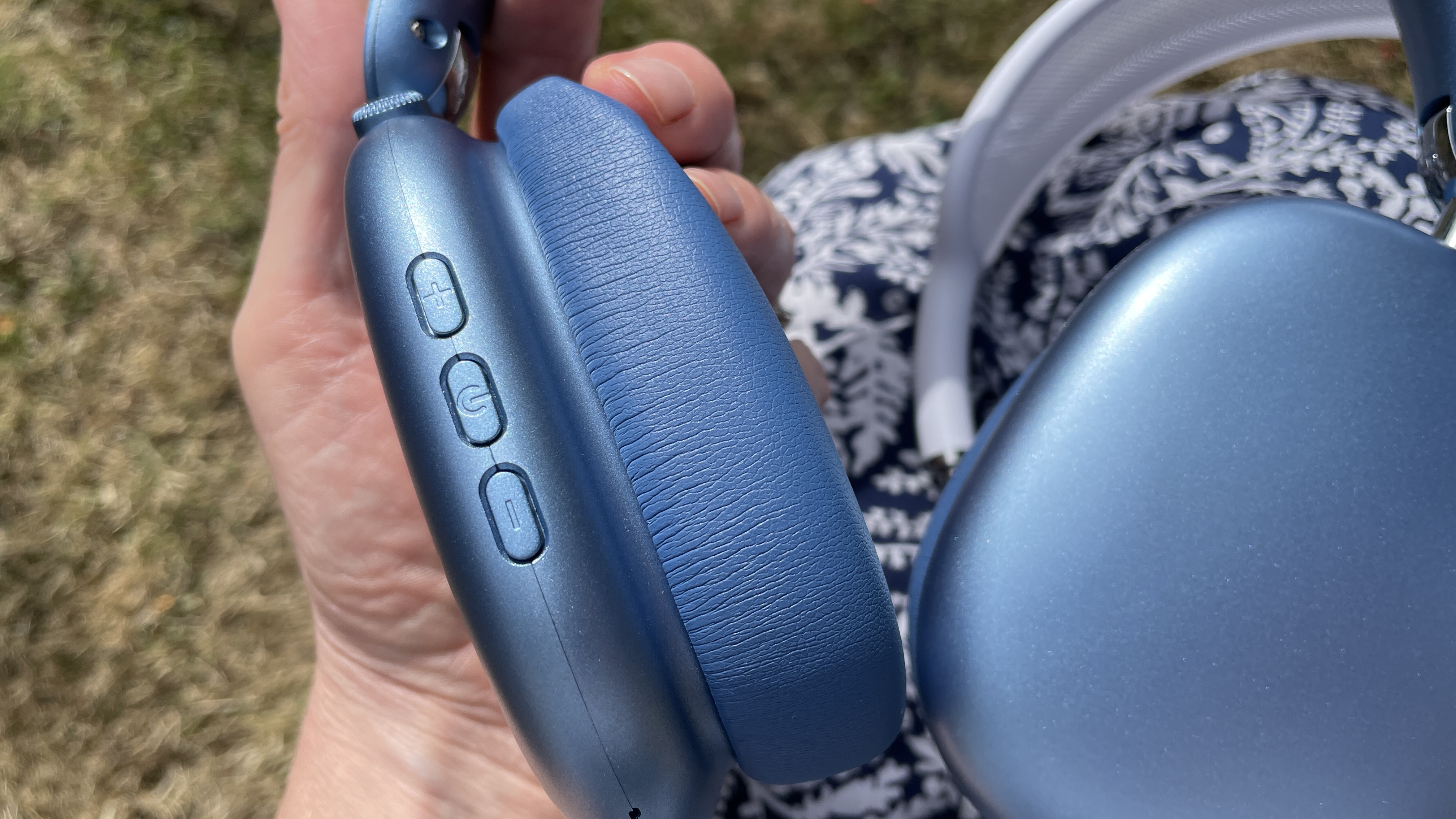 Wentronic YO1 (AirPods Max dupe) headphones in blue with AirPods Max nearby to compare and contrast their looks, outside on a sunny day