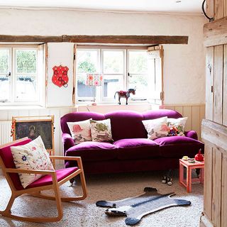 living area with pink sofa and arm chair