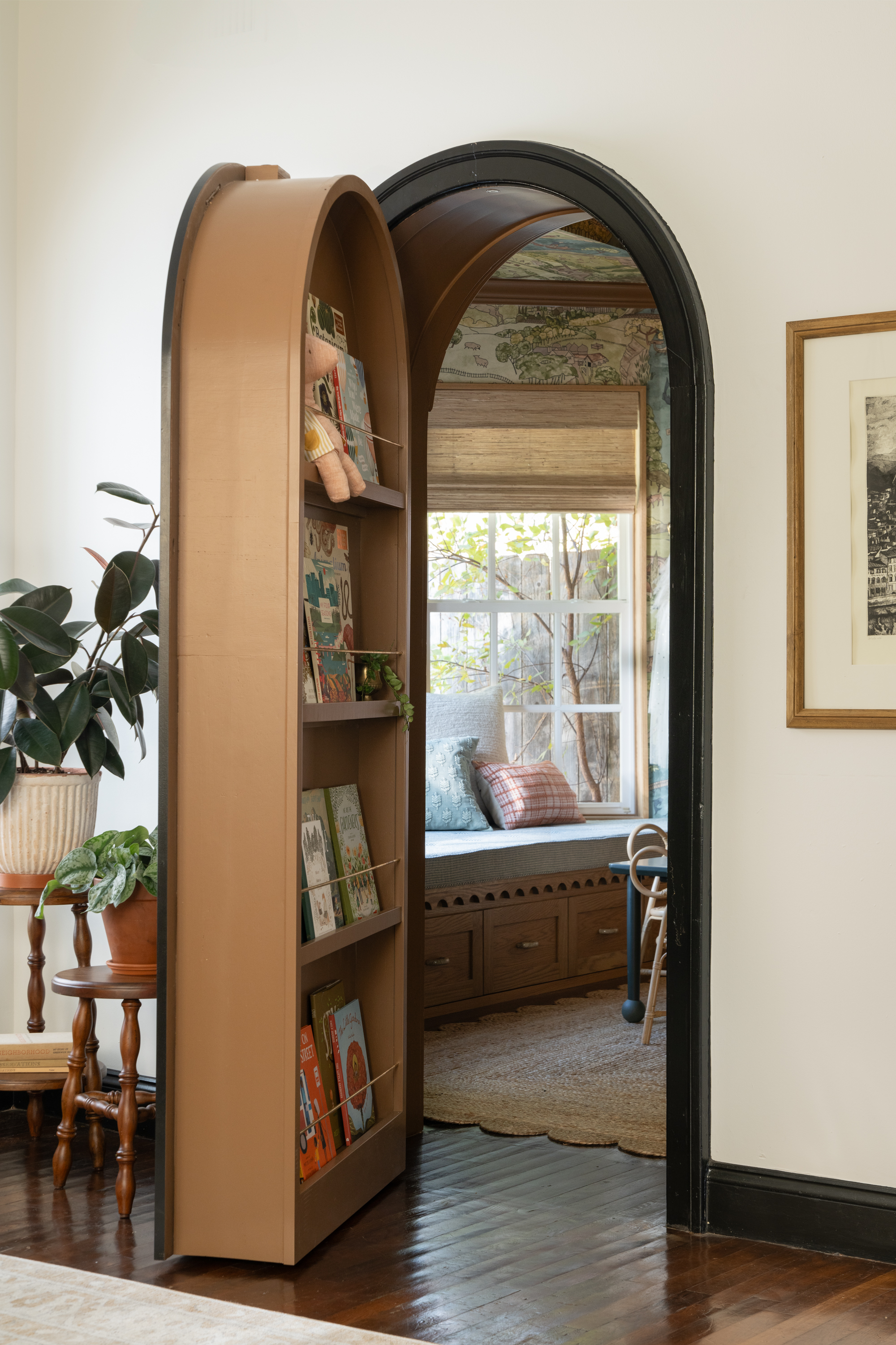 Secret doorway with arch looking into nursery with window seat