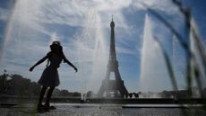 A girl cools off in a Paris fountain during the 2022 summer heatwave.