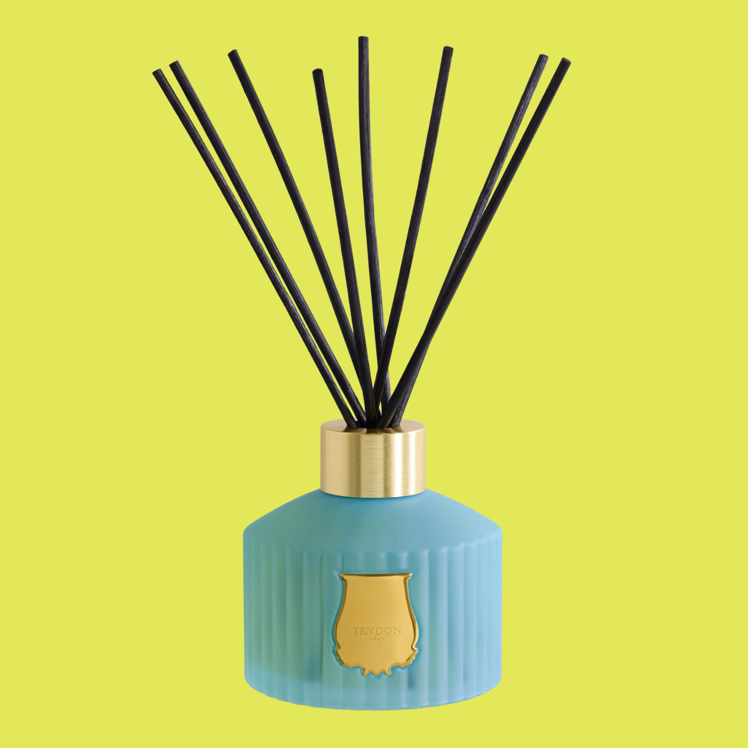 A blue diffuser bottle against a neon yellow background