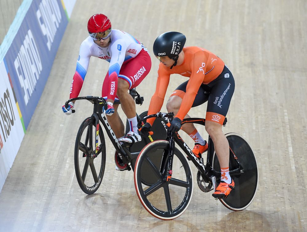 Russia's Denis Dmitriev (L) competes for the gold medal in the men's sprint final with Harrie Lavreysen of the Netherlands at the 2017 Track Cycling World Championships