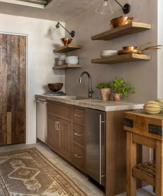 small wooden rustic kitchen with modern black wall sconces