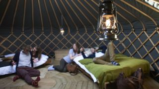 A group of glampers hanging out in their yurt