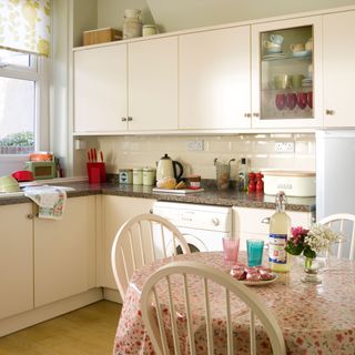 kitchen with retro style storage canisters china and glass in glass fronted cabinet and cottage style table