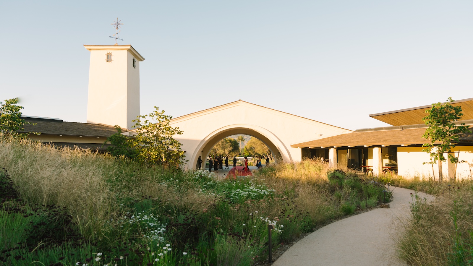 Robert Mondavi Winery's signature tower and arch in spring 2026 after the renovation, with natural landscaping in the foreground