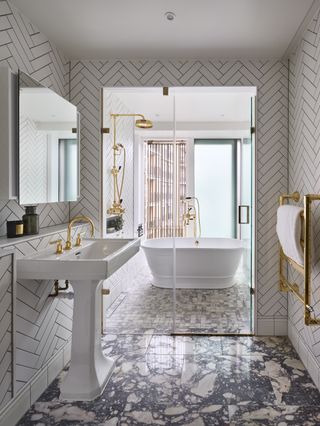 Bathroom with a mix of marble floor tiles and chevron wall tiles