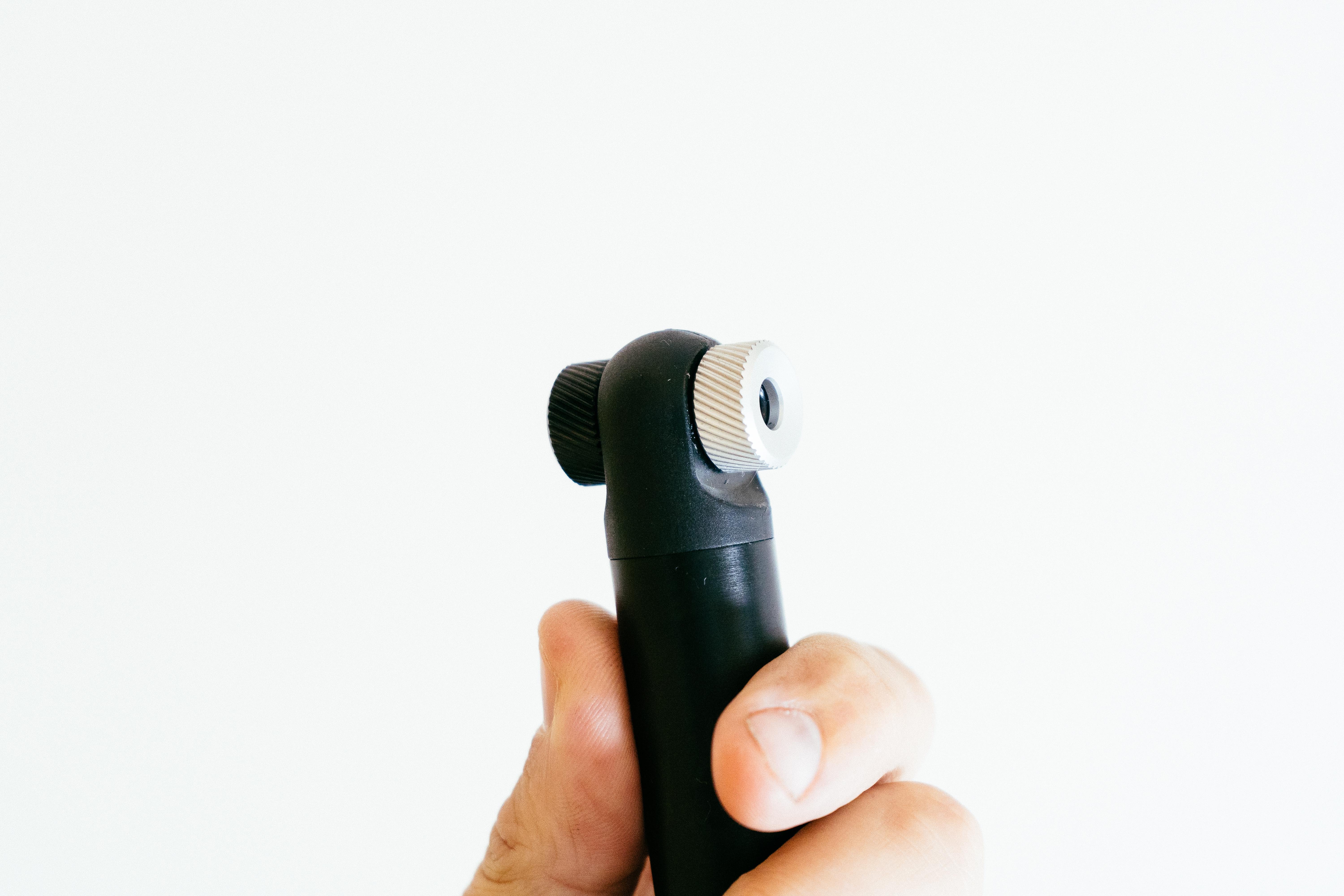 A close up of the head of a black bike pump