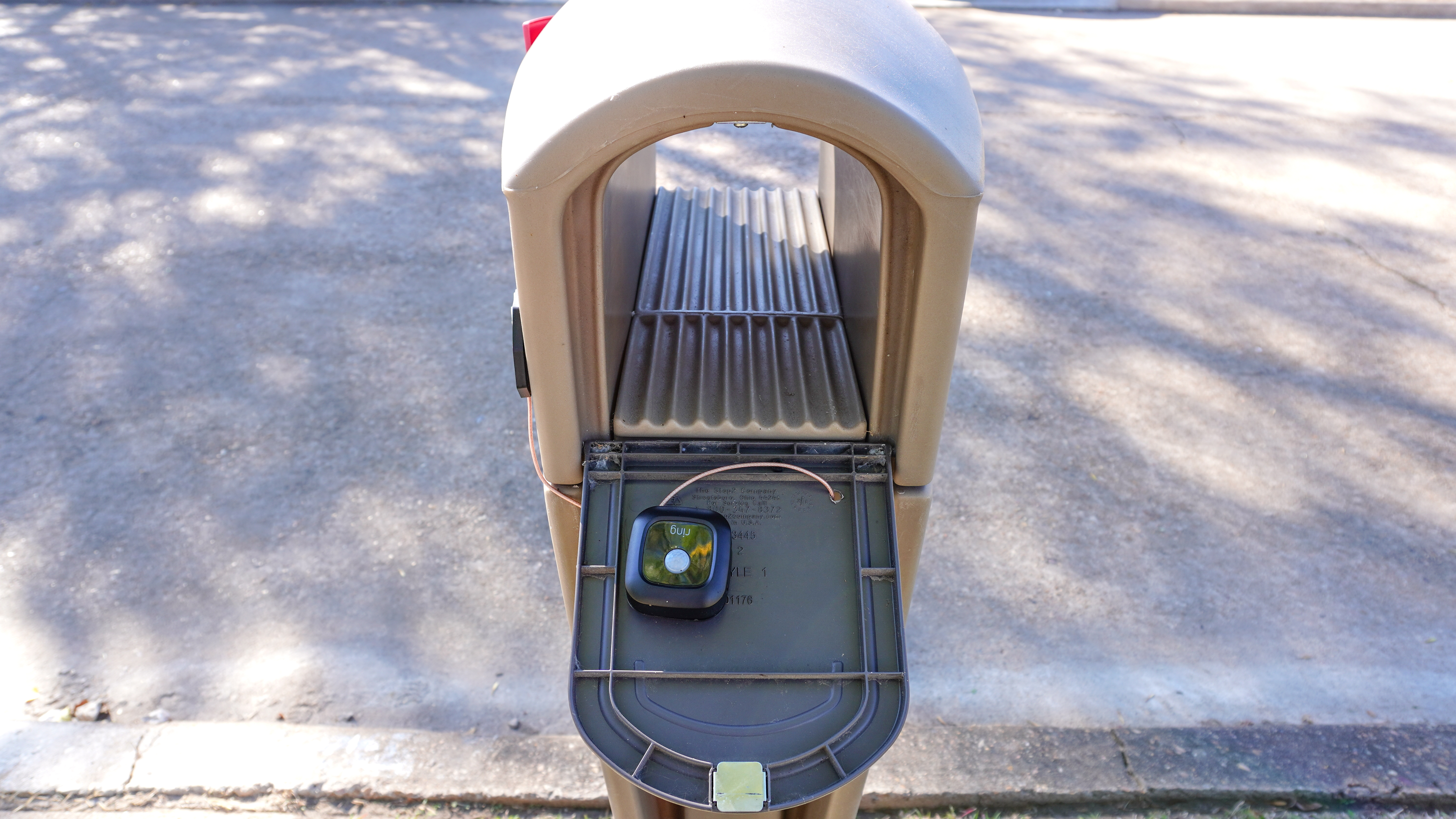 A Ring Mailbox Sensor installed in the back of a mailbox