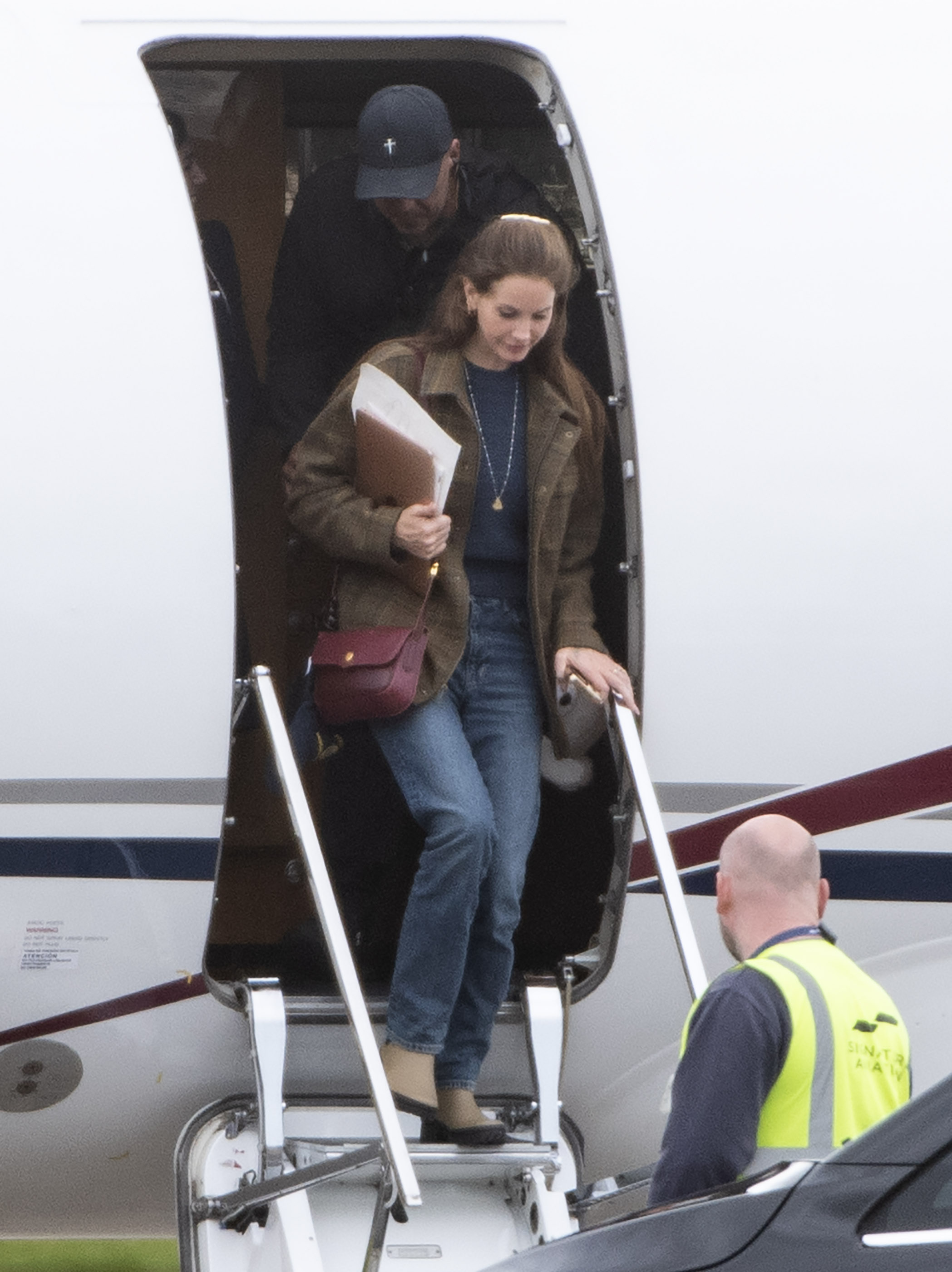 Lana Del Rey arriving for her tour in the UK wearing a brown blazer and jeans.