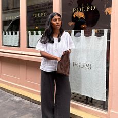 Influencer wearing a white top and brown pants in London