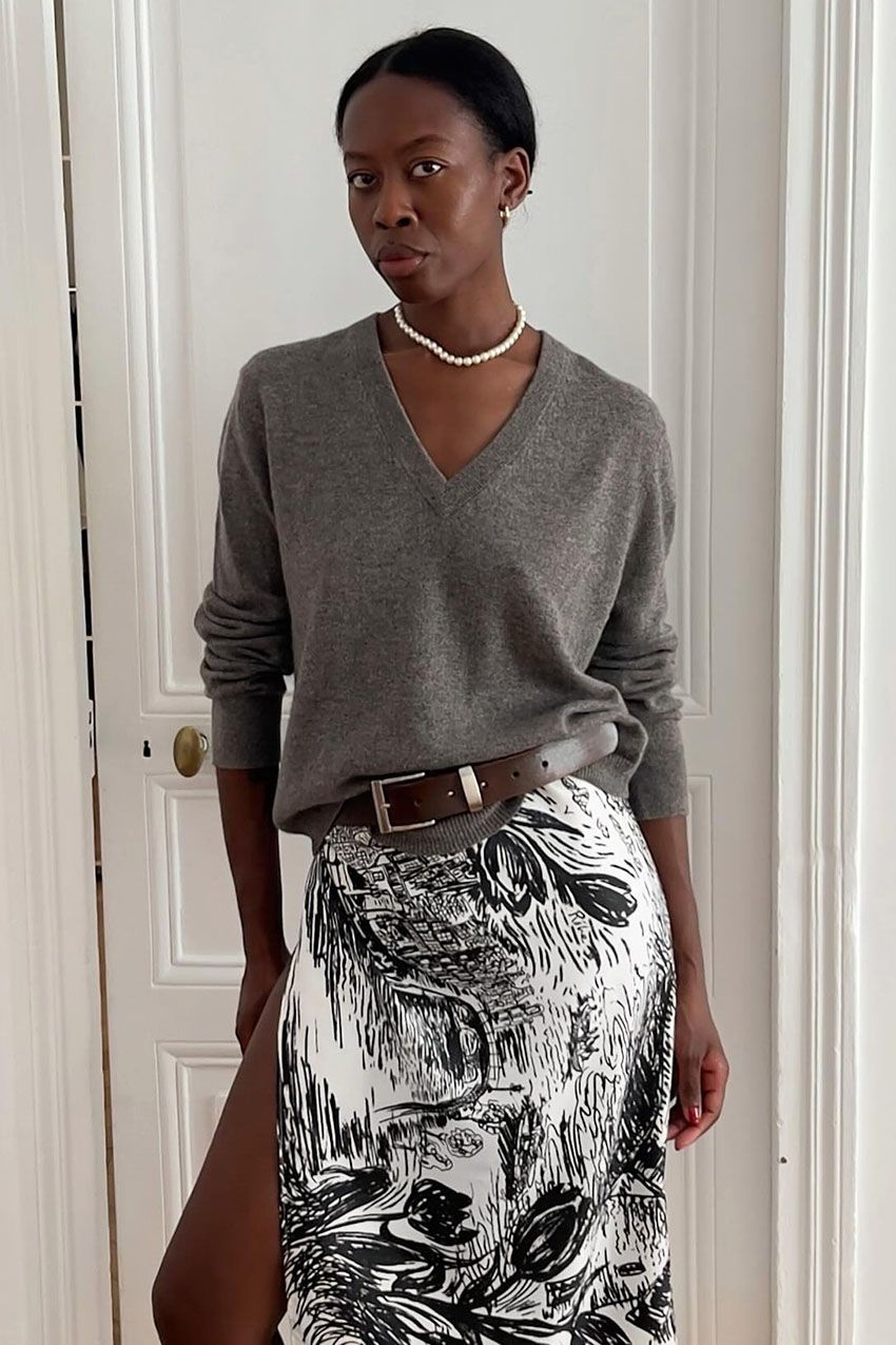 A woman wearing a gray sweater.
