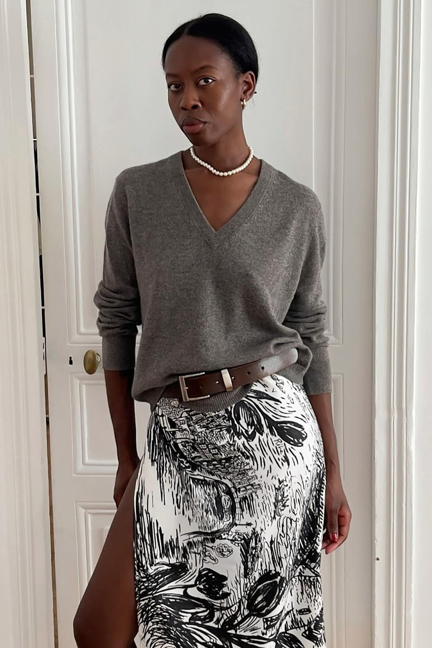 a woman wearing a gray sweater