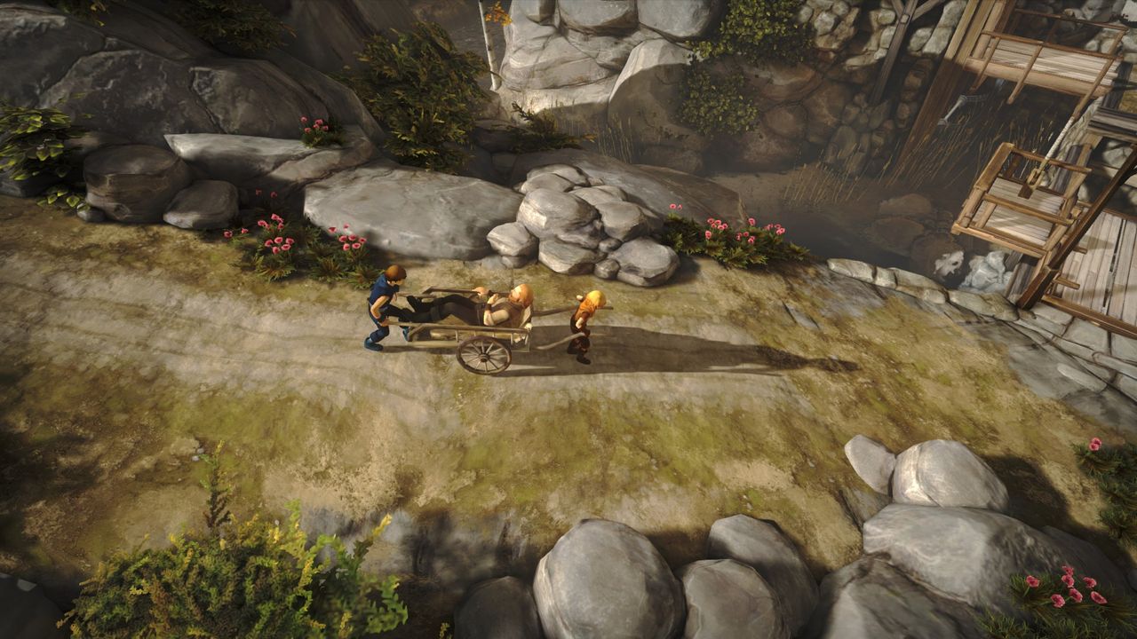 The two brothers carrying their ill father in a cart in Brothers: A Tale of Two Sons.