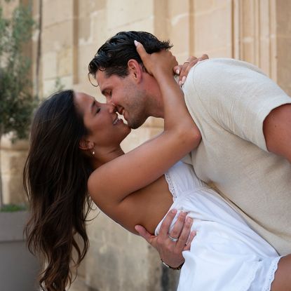 A man (Tim Demirjian) holds a woman (Gia Aldisert) in a dip as they nearly kiss, while standing in a Malta street. A still from the Hulu reality show 'Love Overboard.'