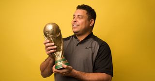 Ronaldo Nazario looks at his 2002 FIFA World Cup winners trophy for Brazil during a photo session on March 12, 2018 in Madrid, Spain.