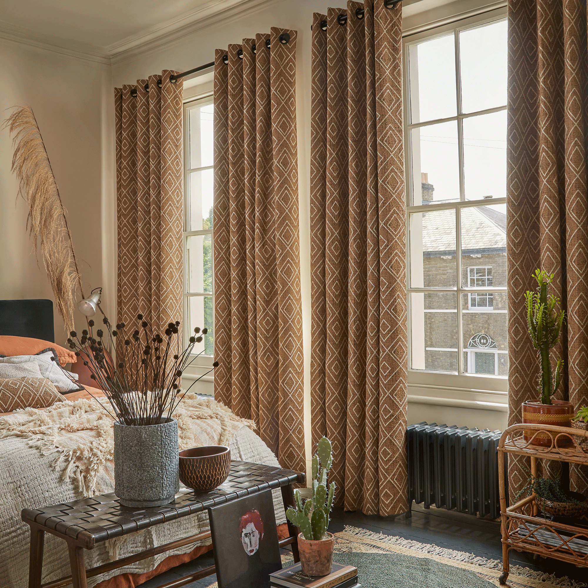 Brown patterned curtains in beige bedroom