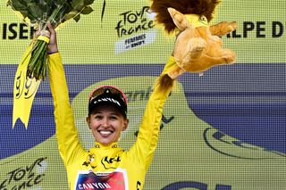 Canyon//SRAM Racing team's Polish rider Katarzyna Niewiadoma celebrates on the podium wearing the overall leader's yellow jersey after winning the third edition of the Women's Tour de France cycling race and competing in the 8th and last stage of the Women's Tour de France cycling race, a 149.9 km between Le Grand Bornand and the Alpe d'Huez, in L'Alpe d'Huez, south-eastern France, on August 18, 2024. (Photo by JULIEN DE ROSA / AFP)