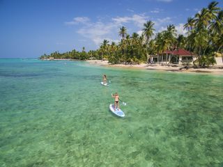 two women paddle boarding in Tobago