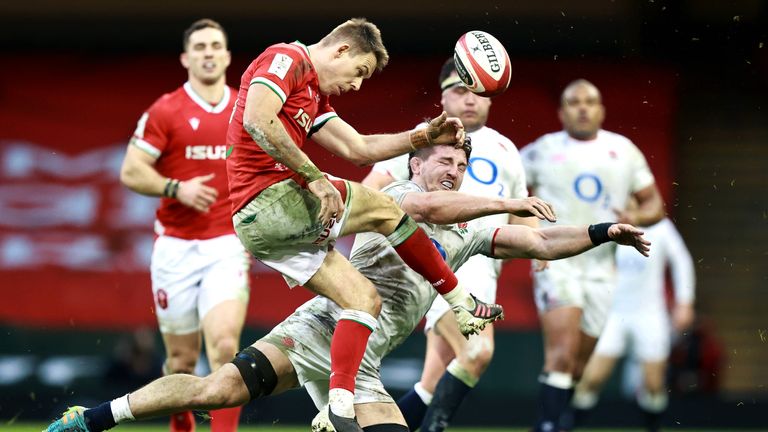 Liam Williams of Wales kicks upfield as Tom Curry of England charges down during the Guinness Six Nations match between Wales and England