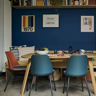 Retro style dining room with wood extending dining table and orange and blue chairs