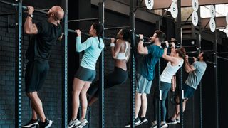 Row of people performing pull-ups