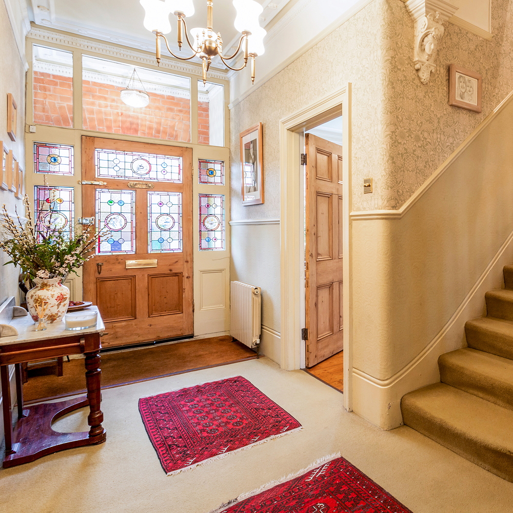 under brickwork porch and through wonderful stained glass front door
