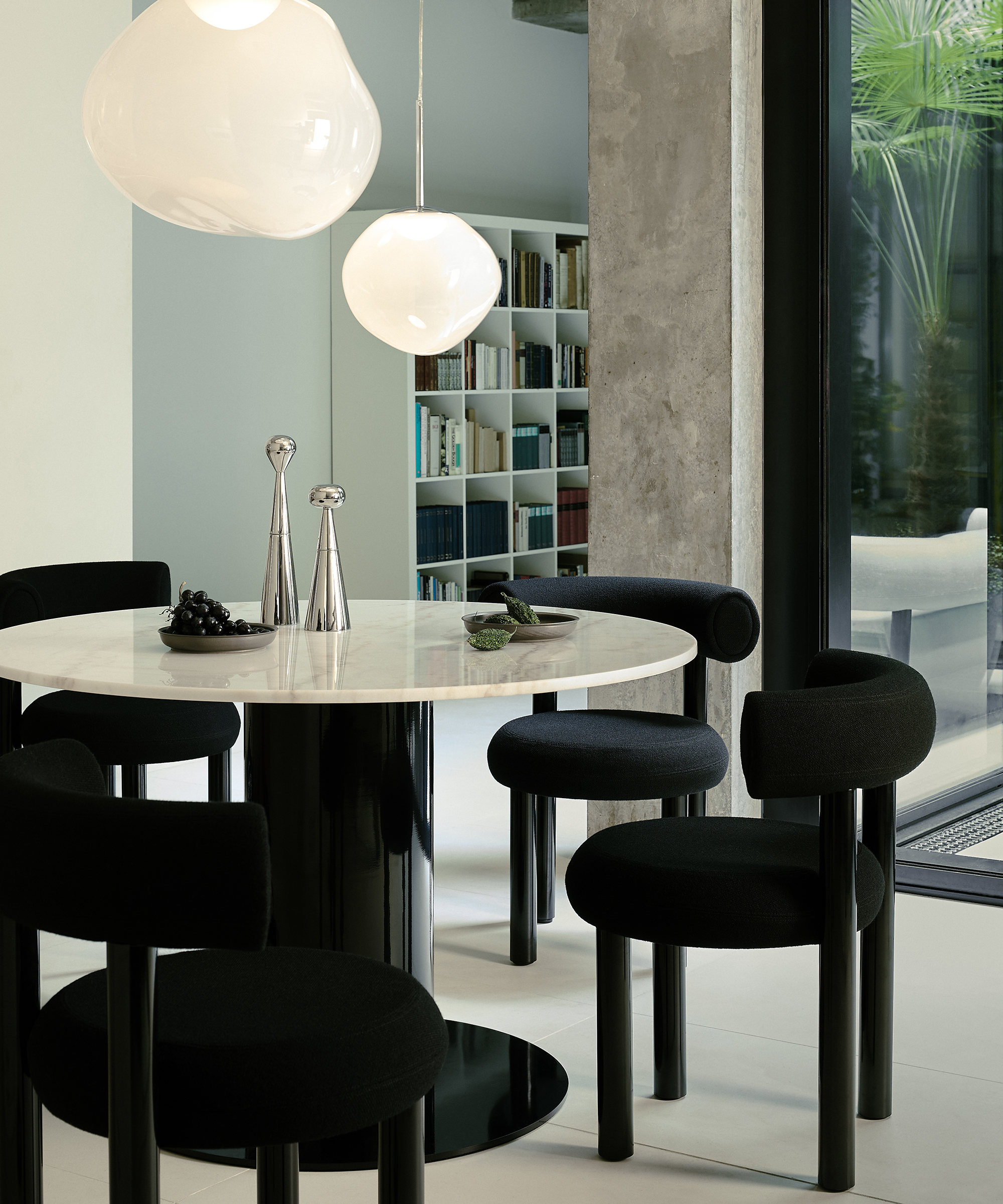 black dining chairs around a round dining table