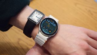 Samsung Galaxy Watch 7 on a wrist next to a old-fashioned watch