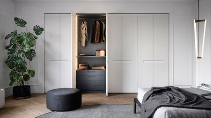 A large built in closet with sliding doors in a bedroom