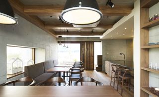 small restaurant dining area with view to door with wooden tables and benches