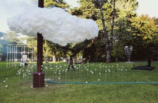 Teacups under cloud sculpture