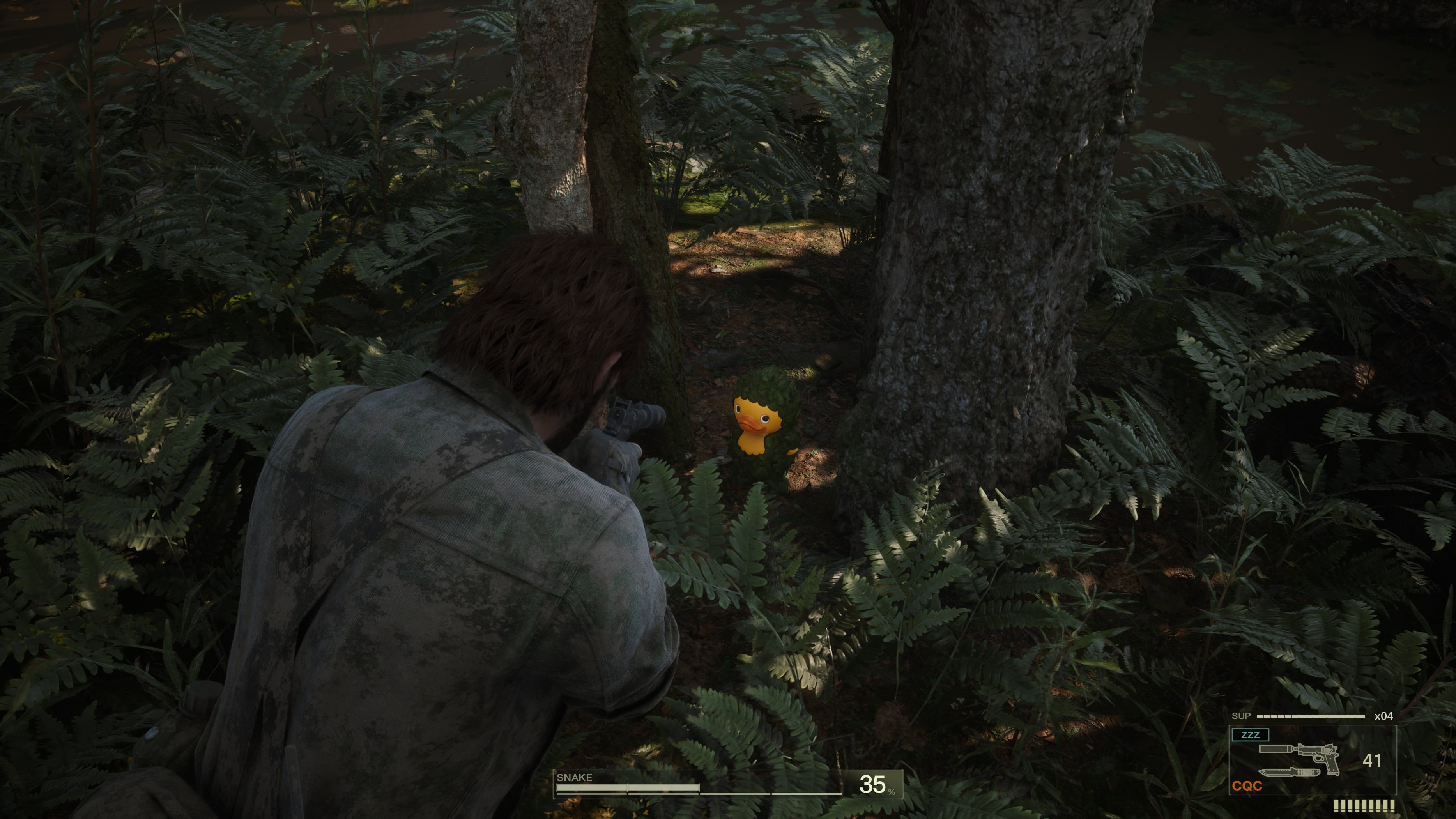 Naked Snake pointing his gun at a collectible frog in Metal Gear Solid Delta: Snake Eater