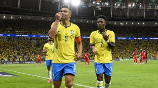 Brazil's Casemiro celebrating with Vinicius Junior