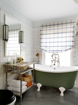 A bathroom with check patterned curtains