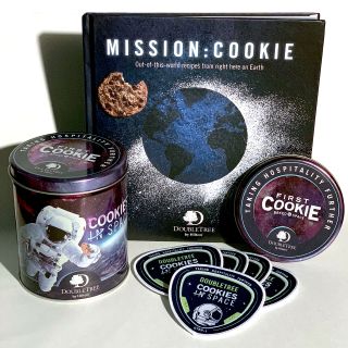 DoubleTree by Hilton's "Cookes in Space" commemorative tin, "Mission: Cookie" cookbook and mission patch.
