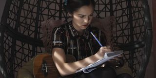 Olivia Rodrigo writing a song down in High School Musical series